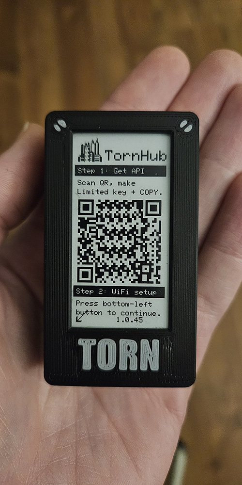 TornHub in a hand showing the QR setup screen.